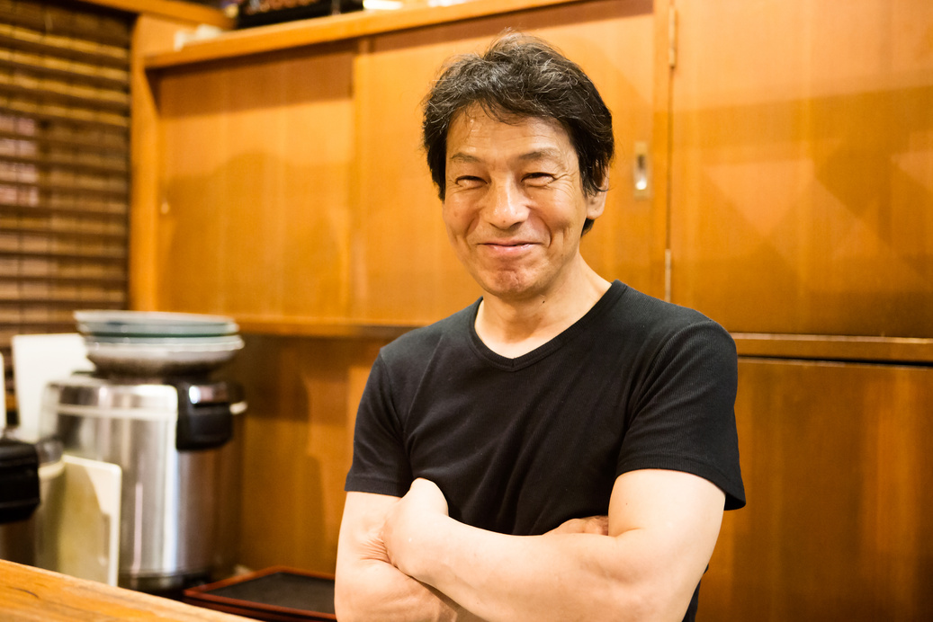 Izakaya shopkeeper showing a smile in the kitchen